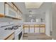Kitchen boasts white cabinetry with wood trim, laminate countertops, and modern appliances at 2819 Bluebonnet Dr # 6, Henderson, NV 89074