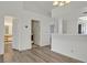 Bright, open-concept living area with wood-look floors and access to the bathroom and laundry room at 2819 Bluebonnet Dr # 6, Henderson, NV 89074