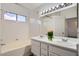 Bright bathroom with double vanity, tiled walls, and shower/tub at 3425 Trilogy Dr, Las Vegas, NV 89108