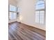 Spacious room featuring high ceilings, large windows, and wood flooring at 3425 Trilogy Dr, Las Vegas, NV 89108