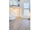 Open-concept living area with staircase, large windows, and bright lighting at 3425 Trilogy Dr, Las Vegas, NV 89108