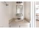 Compact bathroom with a single sink vanity and wall-mounted mirror and light fixture at 3508 Rio Robles Dr # A, North Las Vegas, NV 89030