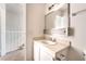 A powder room showing vanity with neutral countertop and the stairway for the upper floor at 3508 Rio Robles Dr # A, North Las Vegas, NV 89030