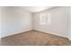 Bedroom with neutral carpet, walls, and a window letting in natural light at 3508 Rio Robles Dr # A, North Las Vegas, NV 89030