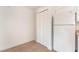 View of bi-fold door pantry and full size refrigerator in minimalist white kitchen at 3508 Rio Robles Dr # A, North Las Vegas, NV 89030