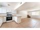 A clean white kitchen with laminate counters opens to a spacious living area with tile floors at 3508 Rio Robles Dr # A, North Las Vegas, NV 89030