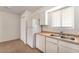 Functional kitchen with white cabinets and essential appliances, enhanced by natural light at 3508 Rio Robles Dr # A, North Las Vegas, NV 89030
