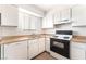 Bright kitchen features white cabinets, laminate counters, and a window over the sink at 3508 Rio Robles Dr # A, North Las Vegas, NV 89030