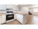 Open floor plan kitchen with white cabinets, laminate countertop, and a black stove at 3508 Rio Robles Dr # A, North Las Vegas, NV 89030