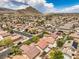 Expansive aerial view of a residential neighborhood with mountain backdrop and well-maintained homes at 3728 Ashling St, Las Vegas, NV 89129