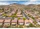 Scenic aerial shot of a quiet, tree-lined neighborhood nestled against majestic mountains at 3728 Ashling St, Las Vegas, NV 89129