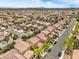 Aerial view showcases a residential neighborhood with neat streets and homes at 3728 Ashling St, Las Vegas, NV 89129