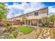 Backyard featuring desert landscaping, rock, synthetic grass and patio space at 3728 Ashling St, Las Vegas, NV 89129
