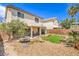 Backyard featuring desert landscaping, rock, synthetic grass and patio space at 3728 Ashling St, Las Vegas, NV 89129
