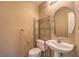 Neat powder room featuring pedestal sink, oval mirror and decorative storage at 3728 Ashling St, Las Vegas, NV 89129