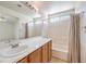 Bathroom featuring a single sink vanity with mirror, tub, and tiled floors at 3728 Ashling St, Las Vegas, NV 89129