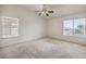 Large, well-lit bedroom with neutral carpet, two windows, and ample natural light at 3728 Ashling St, Las Vegas, NV 89129