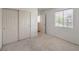 Bedroom featuring neutral carpet, a window, and a sliding door closet at 3728 Ashling St, Las Vegas, NV 89129