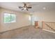 Spacious bonus room featuring neutral carpet, large windows, and a railing overlooking downstairs at 3728 Ashling St, Las Vegas, NV 89129