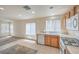 Bright kitchen with wooden cabinets, tile flooring, white appliances, and great natural light at 3728 Ashling St, Las Vegas, NV 89129