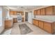 Well-lit kitchen with tile floors, wooden cabinets, white appliances, and ample counter space at 3728 Ashling St, Las Vegas, NV 89129