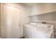 Bright laundry room with appliances, shelf and convenient access door at 3728 Ashling St, Las Vegas, NV 89129