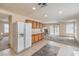Inviting living space with a kitchen, carpeted living area, and sliding glass doors to the backyard at 3728 Ashling St, Las Vegas, NV 89129