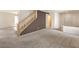 Living room with carpet, staircase, and doorway leading to another room at 3728 Ashling St, Las Vegas, NV 89129