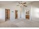 Spacious main bedroom with a ceiling fan, neutral carpet, walk-in closet and adjoining bathroom at 3728 Ashling St, Las Vegas, NV 89129