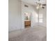Spacious main bedroom featuring carpeted floors, a ceiling fan, and an ensuite bathroom at 3728 Ashling St, Las Vegas, NV 89129