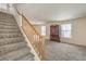 Carpeted staircase leading to the upper level, featuring a wooden handrail and view of the living area at 3728 Ashling St, Las Vegas, NV 89129