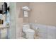 Bathroom featuring a toilet and marble countertop sink area with a glass shower door at 4381 W Flamingo Rd # 1109, Las Vegas, NV 89103