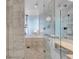 Bright bathroom with a glass shower, a soaking tub, and elegant marble finishes at 4381 W Flamingo Rd # 1109, Las Vegas, NV 89103