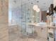 Elegant bathroom with marble tile, glass-enclosed shower, and modern fixtures at 4381 W Flamingo Rd # 1109, Las Vegas, NV 89103