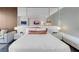Cozy bedroom with a mirrored wall, luxury bedding, side tables, and a comfortable seating area at 4381 W Flamingo Rd # 1109, Las Vegas, NV 89103