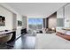 Bright bedroom features a city view, built-in shelves, a TV, and comfortable seating for relaxing at 4381 W Flamingo Rd # 1109, Las Vegas, NV 89103