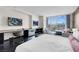 Inviting bedroom with dark hardwood floors, large window, and comfortable furniture plus dual entertainment centers at 4381 W Flamingo Rd # 1109, Las Vegas, NV 89103