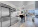Sleek, stainless steel kitchen with modern appliances and adjacent seating area at 4381 W Flamingo Rd # 1109, Las Vegas, NV 89103