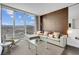 Open-concept living area with cityscape views, a comfortable sofa, a lounge chair, and stylish furnishings at 4381 W Flamingo Rd # 1109, Las Vegas, NV 89103
