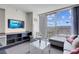 Bright living room with floor-to-ceiling windows showcasing a city view, comfortable seating, and modern décor at 4381 W Flamingo Rd # 1109, Las Vegas, NV 89103