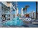 Contemporary pool and spa area with luxurious lounge chairs, tables, and palm trees at 4381 W Flamingo Rd # 1109, Las Vegas, NV 89103