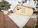 Spacious backyard with concrete patio, shed, and a decorative swing at 4484 Warbonnet Way, Las Vegas, NV 89147