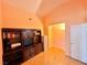 Bright bedroom featuring hardwood floors, a vaulted ceiling, and a built-in media center at 4484 Warbonnet Way, Las Vegas, NV 89147