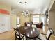 Open-concept living/dining room with chandelier and hardwood floors adjacent to front entry and bedrooms at 4484 Warbonnet Way, Las Vegas, NV 89147