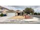 Charming single-story home featuring a two-car garage and low-maintenance desert landscaping at 4484 Warbonnet Way, Las Vegas, NV 89147