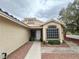 Inviting entrance with a decorative window, tiled roof, and a walkway lined with desert landscaping at 4484 Warbonnet Way, Las Vegas, NV 89147