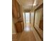 Hallway with wood cabinets and a full-length mirror at 4484 Warbonnet Way, Las Vegas, NV 89147
