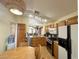 Functional kitchen featuring modern appliances, wooden cabinets, and a connected breakfast nook at 4484 Warbonnet Way, Las Vegas, NV 89147