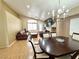 Open-concept living/dining room area with hardwood flooring and vaulted ceilings with lots of natural light at 4484 Warbonnet Way, Las Vegas, NV 89147