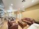 Open-concept living area with dining room and kitchen, hardwood floors, recessed lighting, and fireplace at 4484 Warbonnet Way, Las Vegas, NV 89147